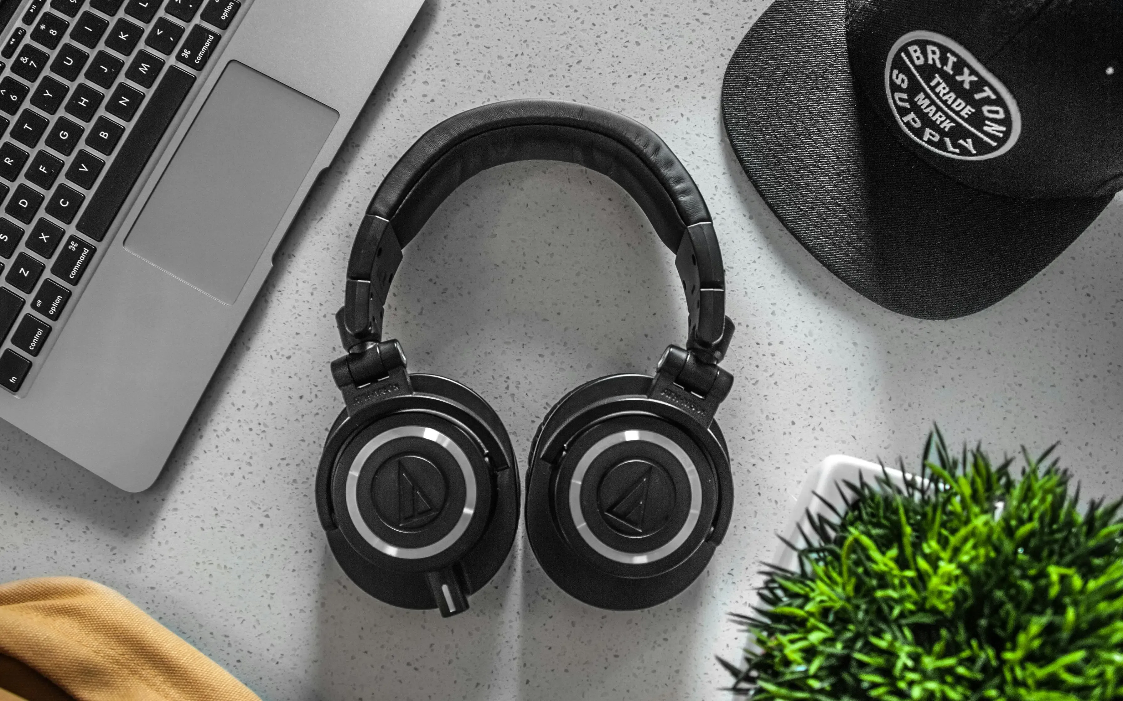 A black headphones lying on a table. A black headphones lying on a table.